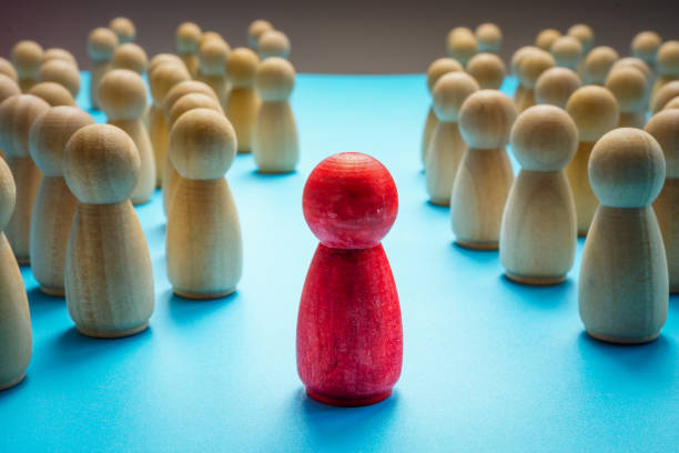 istock Red figure stand out from the crowd and leader concept. 1297375259