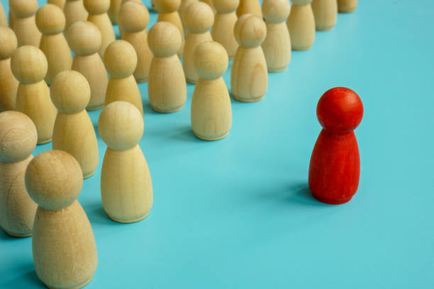 istock Red figure stands out from the crowd. Be unique and different concept. 1297376134