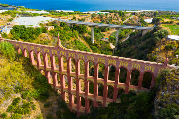 View of restored Eagle Aqueduct (Puente del Aguila) with four levels of arches passing water for local irrigation in Spanish city of Nerja
