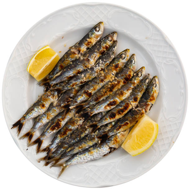 istock Espeto de sardinas with slice of lemon 1297379003