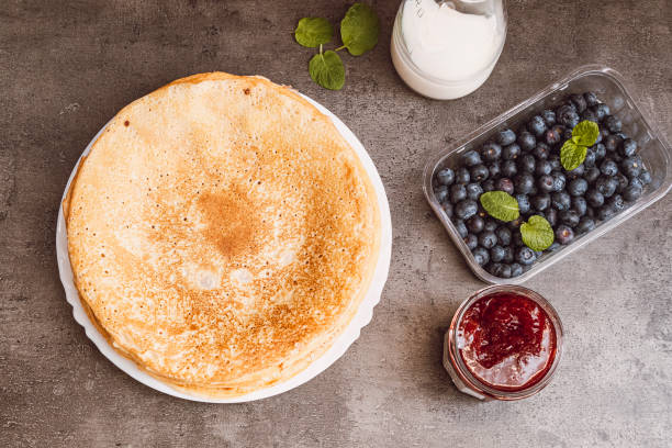 istock Sweet breakfast. Pancakes with blueberries and strawberry jam. View from above 1297380119