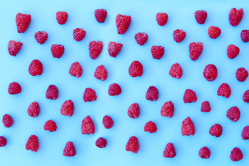 Raspberry pattern, blue background, top view
Pattern of ripe red raspberry on blue background. Vegan food, detox concept