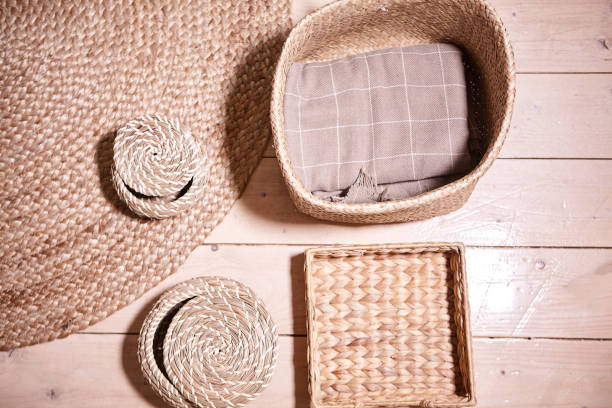 istock Straw wicker basket and white natural cotton fabric. Marie Kondo's storage boxes, containers and baskets with different sizes and shapes for tidying up wardrobe. KonMari method organizer boxes set. 1297382032