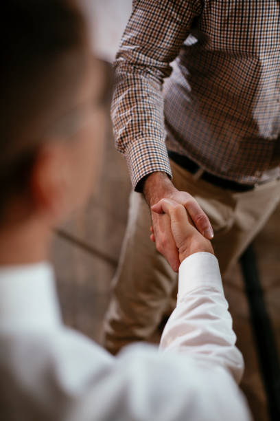 istock Close up of men handshake in office. 1297382932