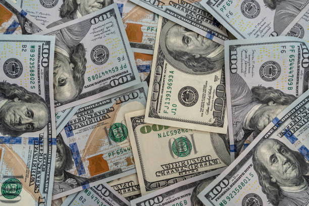 istock Close up view of money stack of 100 US dollars banknotes 1297383019