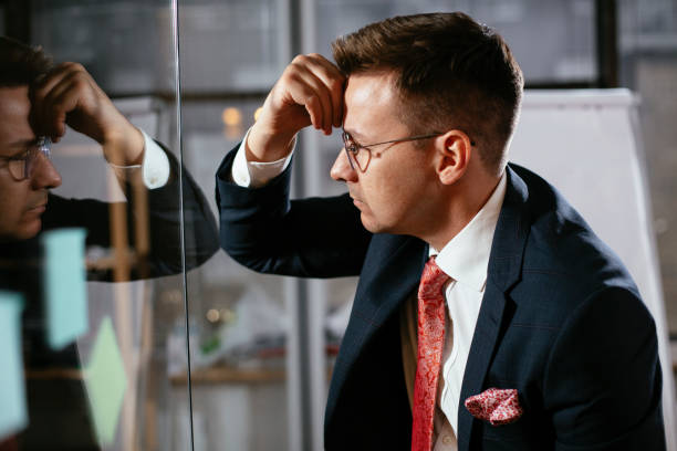 istock Exhausted businessman in conference room 1297383020
