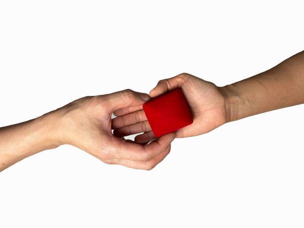 istock Hands delivering red gift boxes to each other on a white background 1297384495