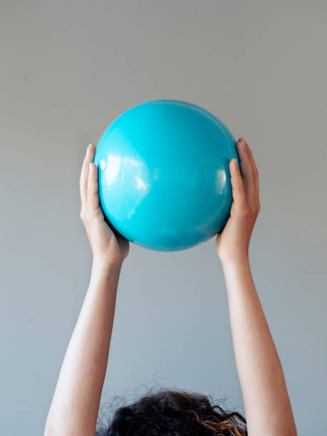 istock woman holding blue plastic ball 1297384497