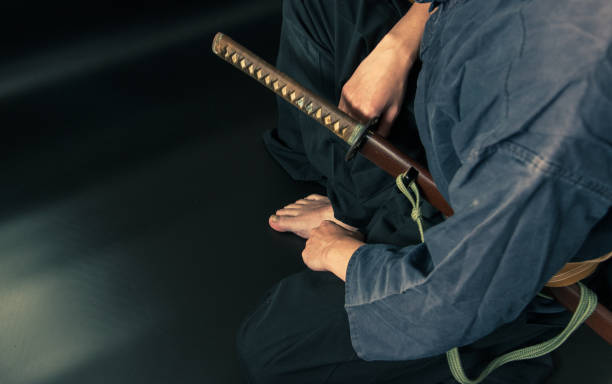 istock A seated man holding his sword with one hand. 1297384546