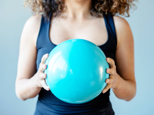 istock woman holding blue plastic ball 1297384652