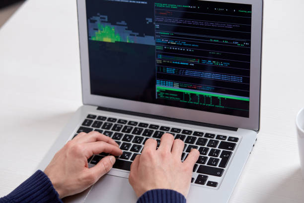 istock A man's hands on a laptop, numbers and codes on the screen. 1297385191