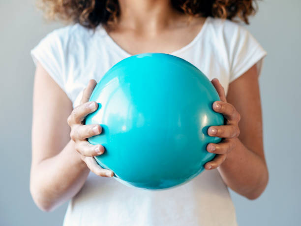 istock woman holding blue plastic ball 1297385560