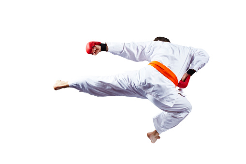 Athlete beats kicking in a jump against a white background