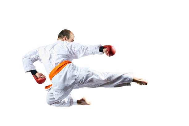 On a white background, an athlete beats a kick in a jump