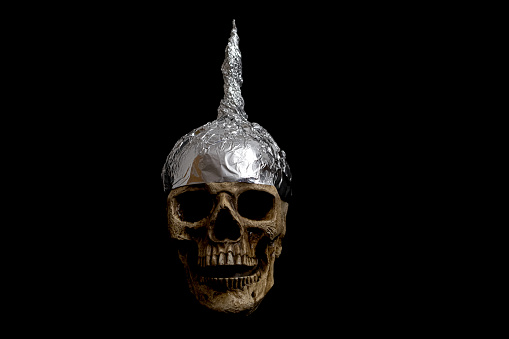 skull wearing a tinfoil hat isolated , black background