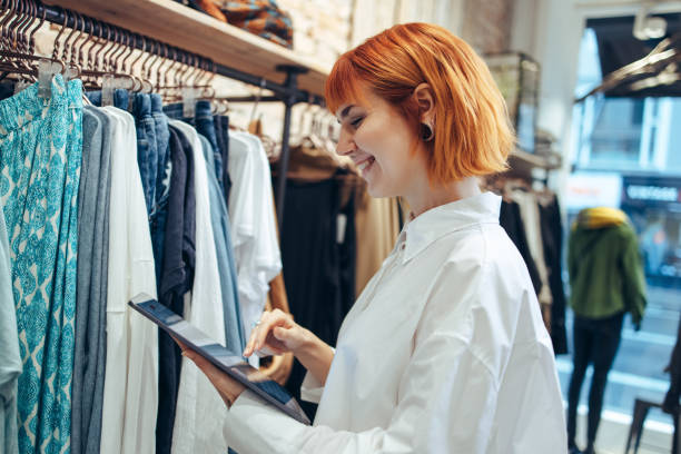 istock Woman in boutique with digital tablet 1297389490