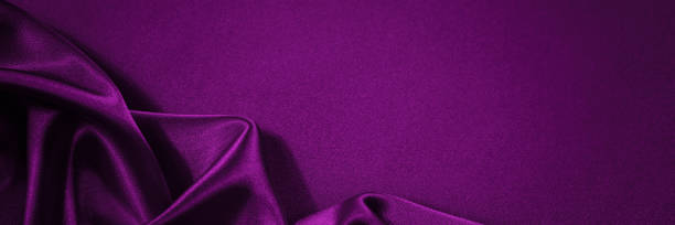 istock Black red silk satin background. Copy space for text or product. Wavy soft folds on shiny fabric 1297389820