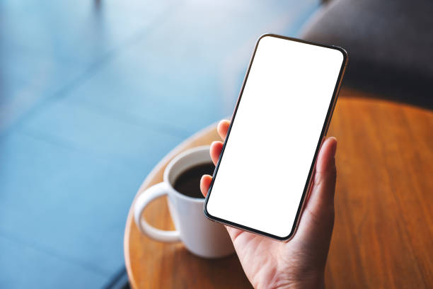 istock a woman holding mobile phone with blank white desktop screen 1297389845