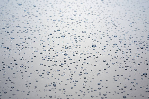 istock Small drops of water on a gray background. 1297390837