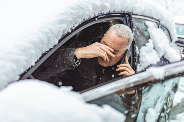 istock Car breakdown on a snowy winter day 1297390879