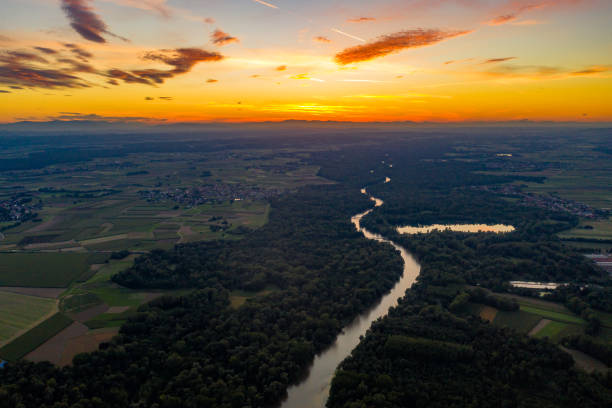 istock Aerial view of river and forest at sunset 1297391536