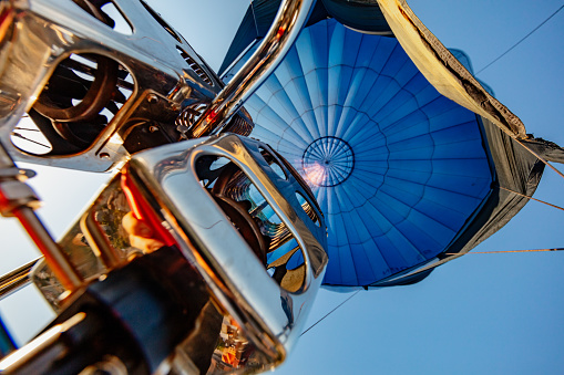 Low angle view of engine of hot air balloon against sky