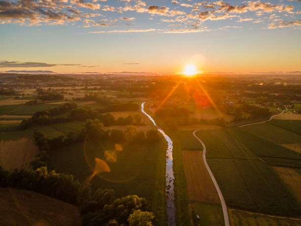 View of green landscape during sunset