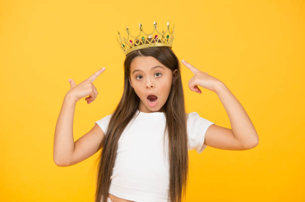 istock completely egoist. surprised child in queen crown. rich royal accessory. dream about future wealth. happy childhood. small girl looking gorgeous. fashion and beauty. pride 1297392805