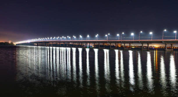 istock Reflection of bright lanterns in the Dnieper river under the bridge 1297393155