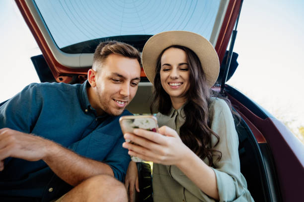 istock Happy couple looking at mobile phone 1297393966