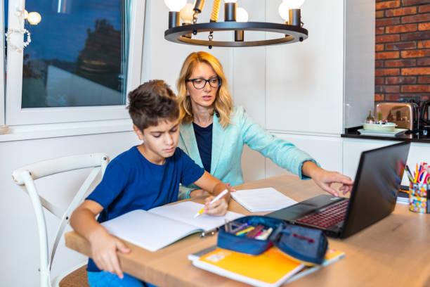 istock Mother and son in video chat with school teacher 1297394151