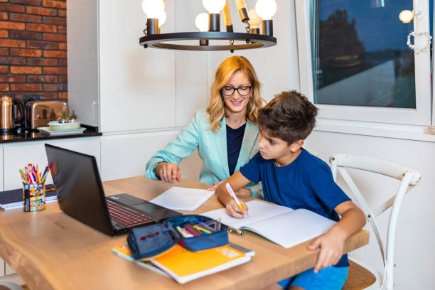 istock Mother and son in video chat with school teacher 1297394158