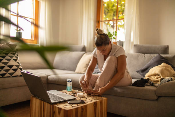 Spa day at home during quarantine Woman filing her toenails sitting on sofa at home home pedicure stock pictures, royalty-free photos & images