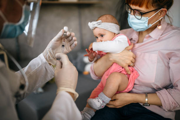 istock Little baby getting vaccinated at doctor's office 1297396216