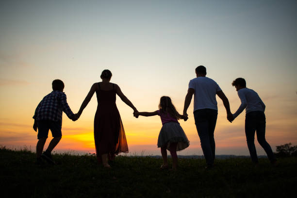 Family walking together on grass field