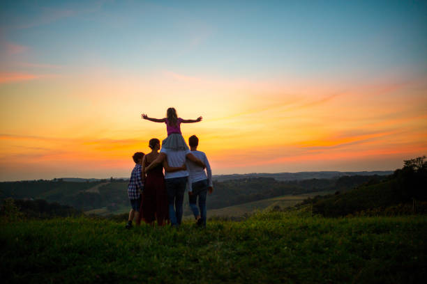 istock Happy family of three during idyllic sunset 1297397523