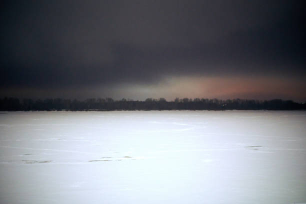 Frosty winter evening on the river.Frost and fog precede a cold night. Night blizzard.