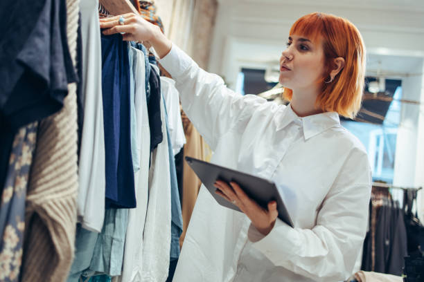 istock Woman taking clothes stock in her store 1297398548