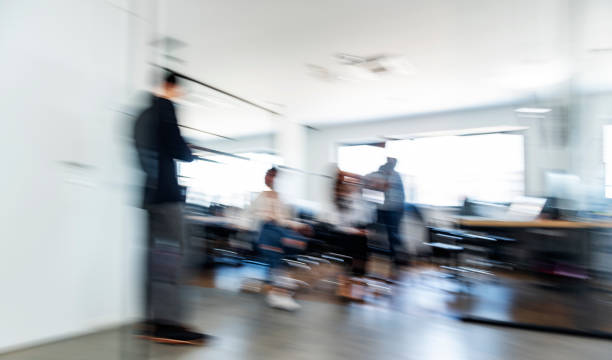 istock Cheerful colleagues having fun in office chairs 1297398898