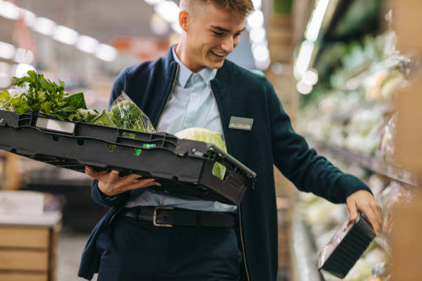 istock Man working in the supermarket produce section 1297401101
