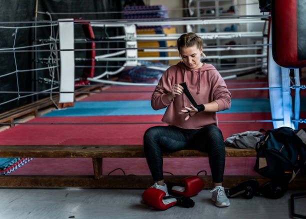 istock Woman wrapping wrist with bandage 1297401355