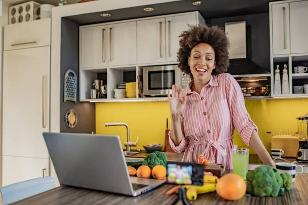 istock Female vlogger in the kitchen preparing healthy drink 1297402403