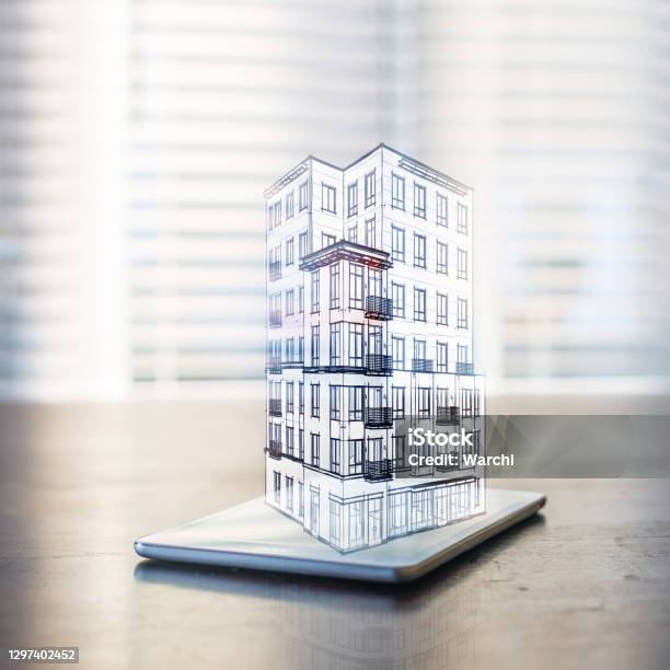 Hologram Of A Building Over A Tablet Computer Stock Photo - Download Image Now - Building Information Modeling, Building Exterior, Construction Industry