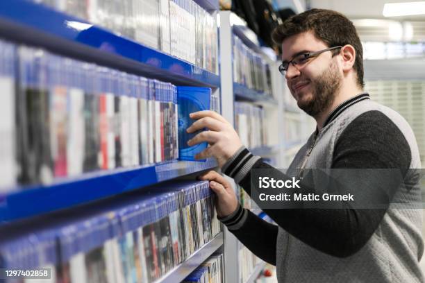 Picking Out Favorite Games Stock Photo - Download Image Now - Store, Video Game, Movie