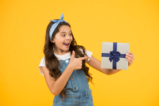 perfect day. shopping online delivery. cheerful kid open wrapped box. best resent ever. gift she expected. small girl customer pointing finger gift. happy holiday celebration. birthday party surprise - happy kid flash imagens e fotografias de stock