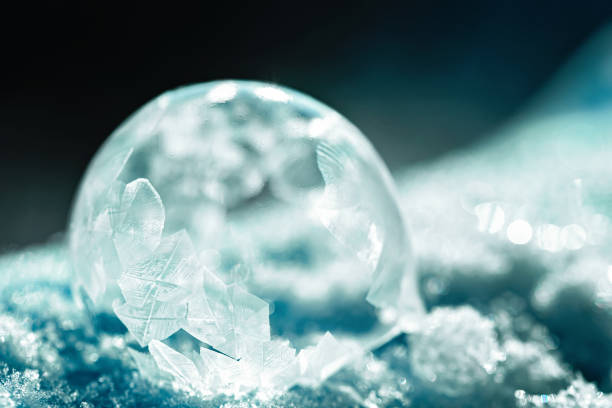 istock frozen bubble with bokeh background. Beautiful frosty patterns on frozen soap bubble 1297403840
