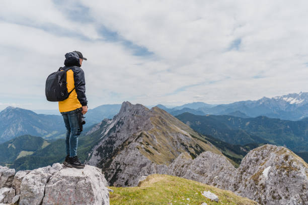 istock Man standing on top of mountain 1297404059