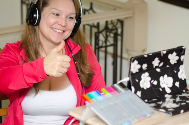istock Woman video conferencing on tablet at home 1297405143