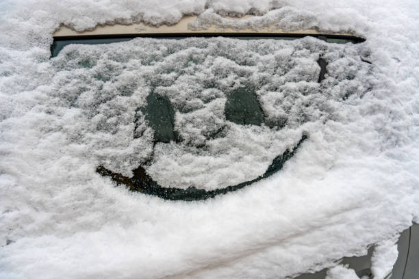 istock Drawn smile on car glass on snow 1297405295