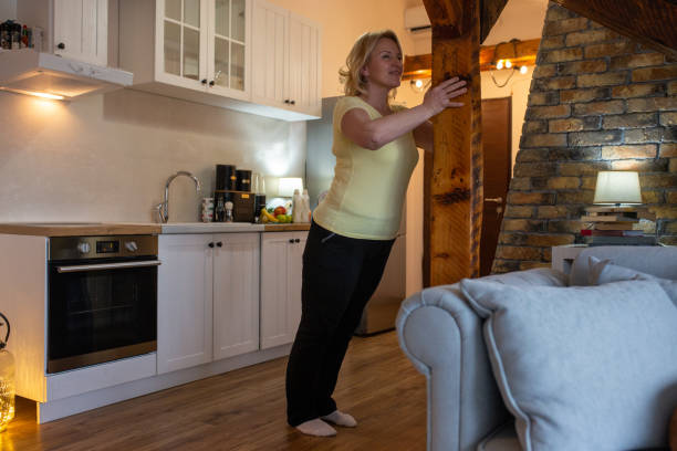 istock Mature Woman Doing Standing Wall Push-ups At Home 1297405640